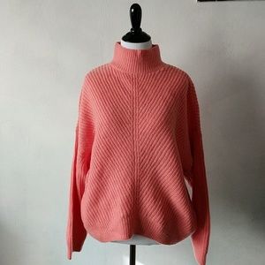 Mockneck peachy orange knit sweater.